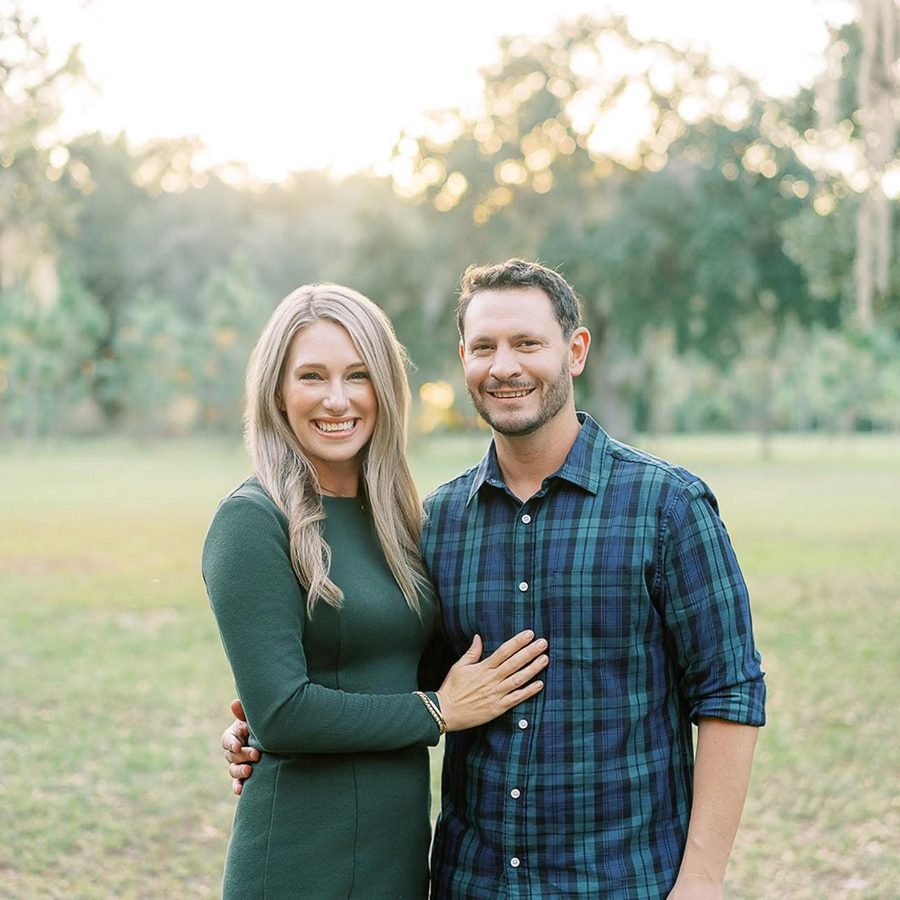 Dr. Nick Healy and his wife Erin, founders of Clarity, smiling together outdoors under oak trees in Winter Garden, Florida